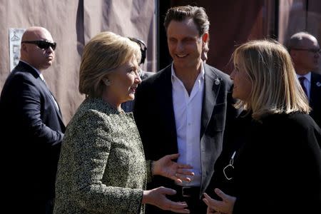 U.S. Democratic presidential candidate Hillary Clinton (L) stops with actor Tony Goldwyn (C) and Nashville Mayor Megan Barry (R) to greet people at Fido coffee shop in Nashville, Tennessee February 28, 2016. REUTERS/Jonathan Ernst