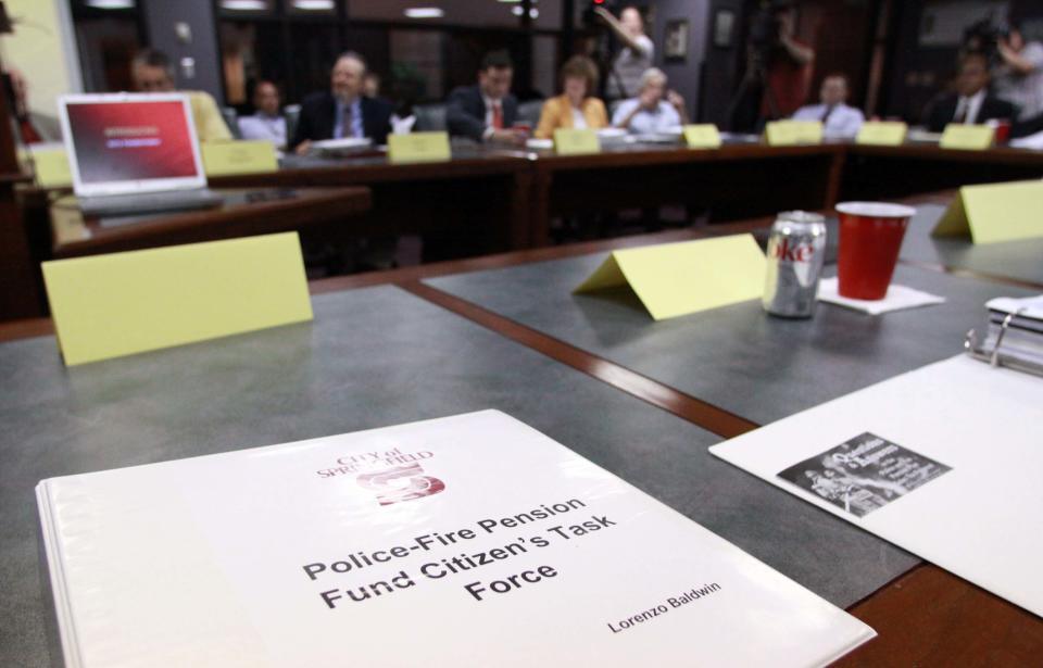 A copy of an information binder for the Police-Fire Pension Fund Citizens' Task Force rests on a table during a meeting in 2009.