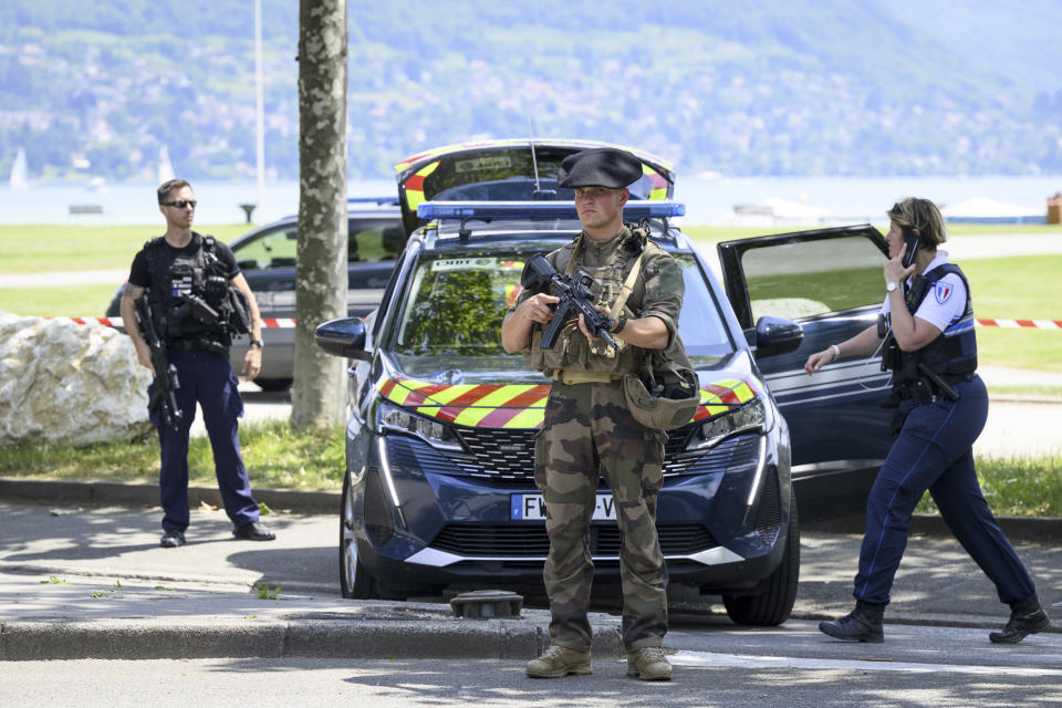 Security forces gather at the scene of knife attack in Annecy, French Alps, Thursday, June 8, 2023. An attacker with a knife stabbed several young children and at least one adult, leaving some with life-threatening injuries, in a town in the Alps on Thursday before he was arrested, authorities said. (Jean-Christophe Bott/Keystone via AP)