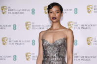 Actress Gugu Mbatha-Raw poses for photographers upon arrival at the Bafta Film Awards, in central London, Sunday, April 11 2021. (AP Photo/Alberto Pezzali)