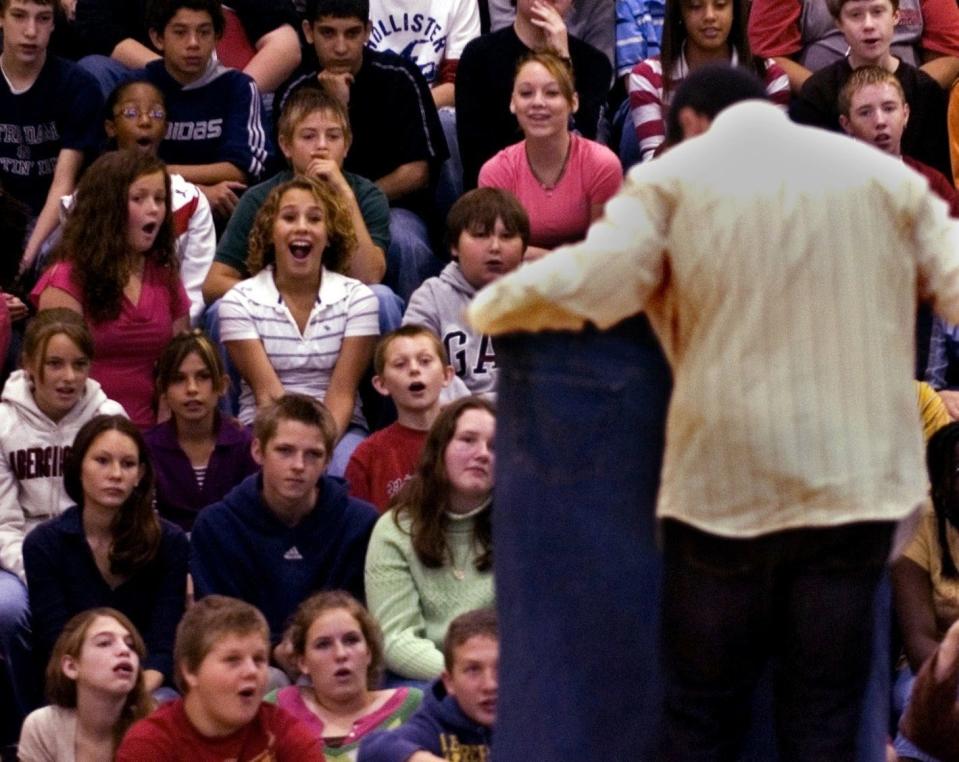 Jared Fogle shows his old pants, with a 60-inch waist, to students at Batchelor Middle School Friday while talking about his weight gain and loss, peaking at 425 pounds and now at 195 pounds. Fogle traces the beginning of his weight gain to his first video game system he got in the third grade. David Snodgress | Herald-Times