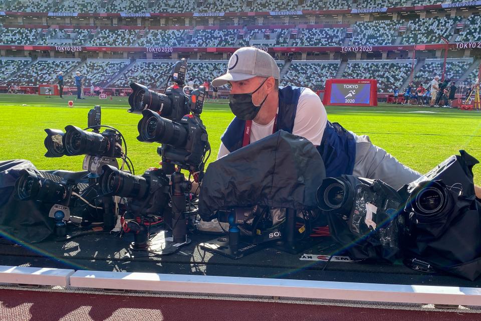 Patrick Smith positions himself behind various cameras while shooting the Tokyo Olympics.