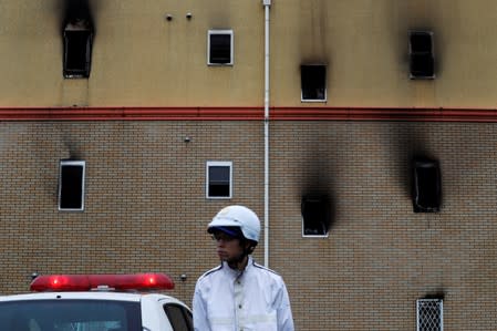 A policeman stands guard in front of the Kyoto Animation building which was torched by arson attack, in Kyoto