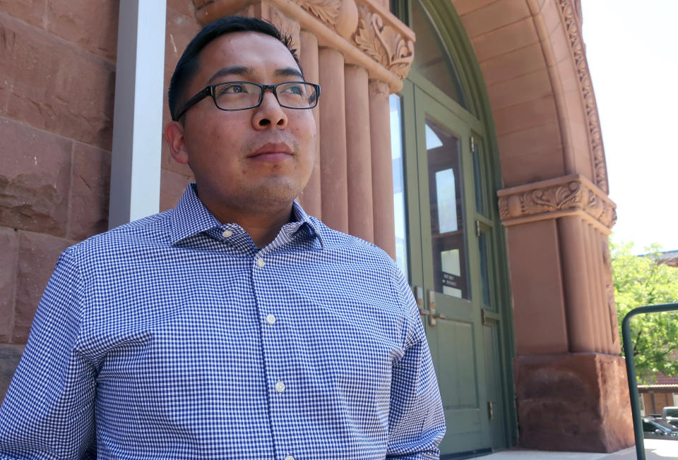 FILE - In this June 28, 2019, file photo, Tremayne Nez stands outside the Coconino County courthouse in Flagstaff, Ariz. In June 2019, police wrongfully arrested him on suspicion of selling LSD after they mistook Nez, who is Navajo, for the actual suspect, also Native American. After spending more than 30 hours in jail in 2019, he posted bond but his mug shot had already been released, tarnishing his reputation throughout the tribal community. Booking photos taken by police when a person is arrested are often made public, but some experts say releasing someone's mug shot can undermine the presumption of innocence, perpetuate stereotypes and leave a lasting virtual stain. (AP Photo/Felicia Fonseca, File)