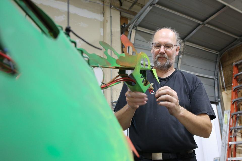 Co-founder David Kent shows one of the fire-breathing dragon sculptures at the Framingham Makerspace, Aug. 10, 2022.