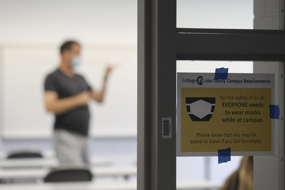 Speech class instructor Robert Gynn, leads a class at College of Lake County in Grayslake, Ill., Thursday, July 8, 2020. Illinois officials say they may fine businesses where employees or patrons aren’t wearing face coverings to slow the coronavirus. Gov. J.B. Pritzker says the emergency rules he filed Friday, Aug. 7, focus on businesses that flout the requirement that people in public must wear masks. (Abel Uribe/Chicago Tribune via AP)