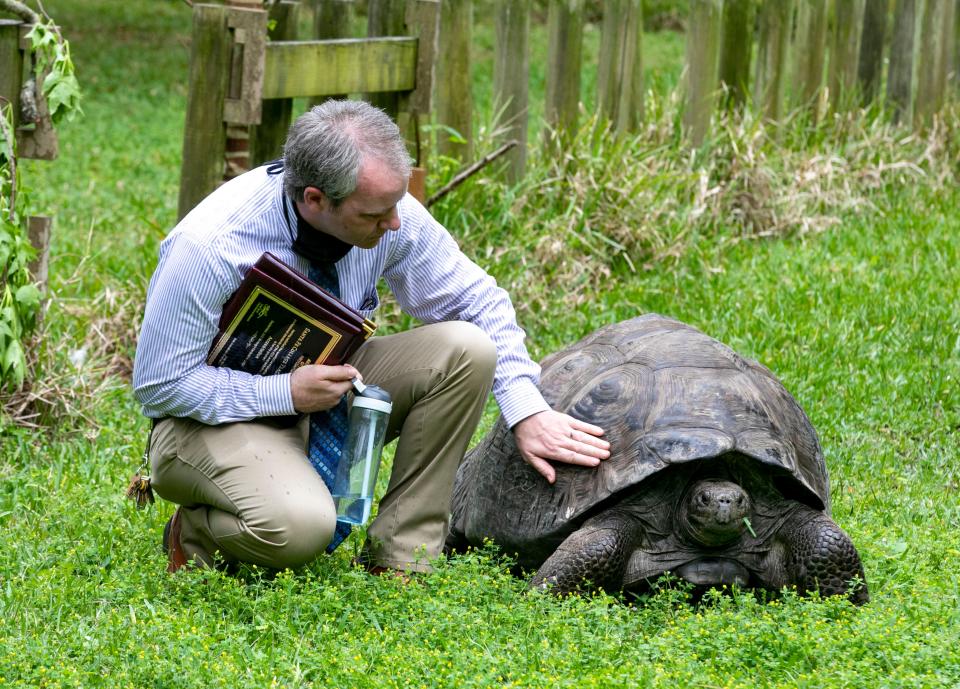 Santa Fe Teaching Zoo Director Jonathan Miot spends a moment with Moe, one of the zoo’s three Galapagos Tortoises, after students and staff at the zoo celebrate another five years of accreditation from the Association of Zoos and Aquariums. The zoo is the only teaching zoo to receive this professional accreditation.  Ashe was on hand to celebrate with the staff and students, which other larger zoos have also received.