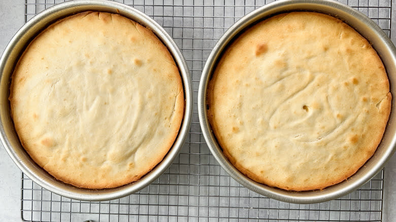 Bright and sunny lemon lavender cake layers cooling in pans on rack