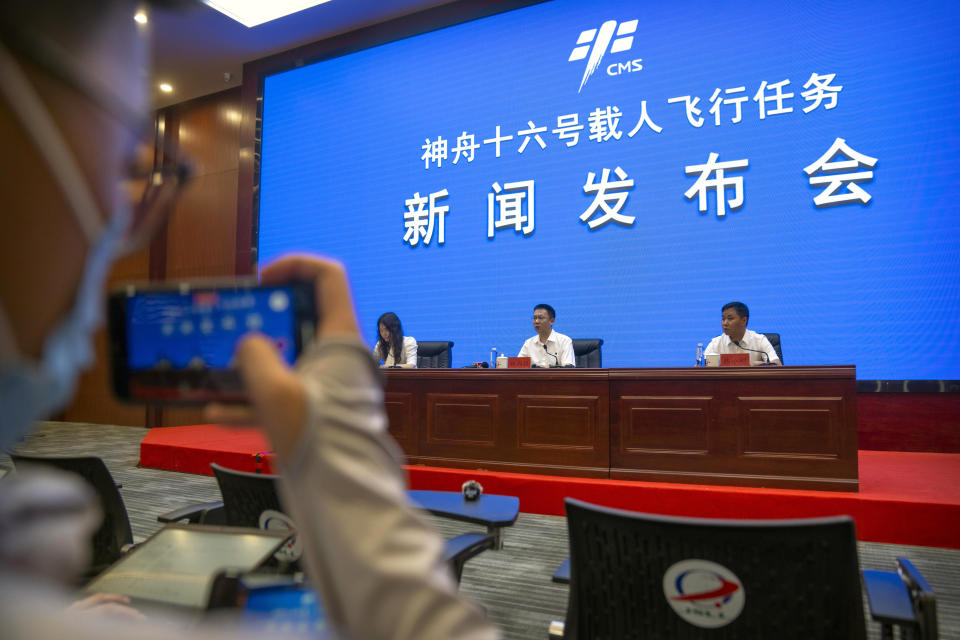 Lin Xiqiang, Deputy Director of the Chinese Manned Space Agency, center, speaks during a press conference at the Jiuquan Satellite Launch Center in northwest China on Monday, May 29, 2023. China's space program plans to land astronauts on the moon before 2030, a top official with the country's space program said Monday. (AP Photo/Mark Schiefelbein)