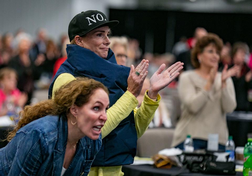 Attendees cheer a point made from the stage during the Florida Summit on Covid at the World Equestrian Center in Ocala on Saturday. A panel of doctors addressed the drug Ivermectin and other alternative drugs as treatment for Covid-19.    [Alan Youngblood/Special to Gainesville Sun]