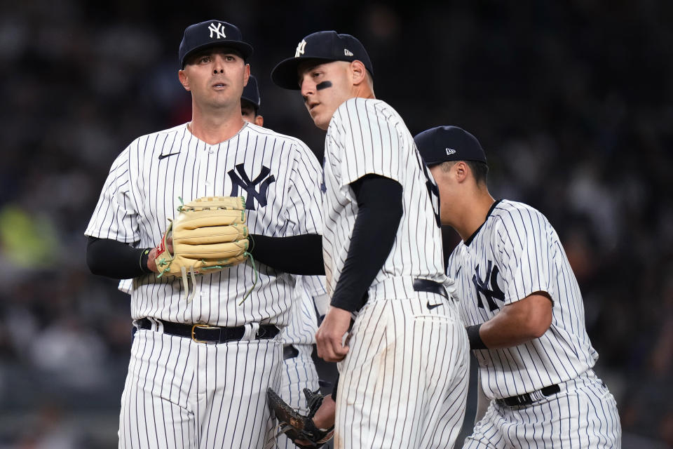 New York Yankees relief pitcher Nick Ramirez, left, is consoled by Anthony Rizzo and Anthony Volpe before leaving during the sixth inning of the team's baseball game against the Baltimore Orioles Thursday, May 25, 2023, in New York. (AP Photo/Frank Franklin II)