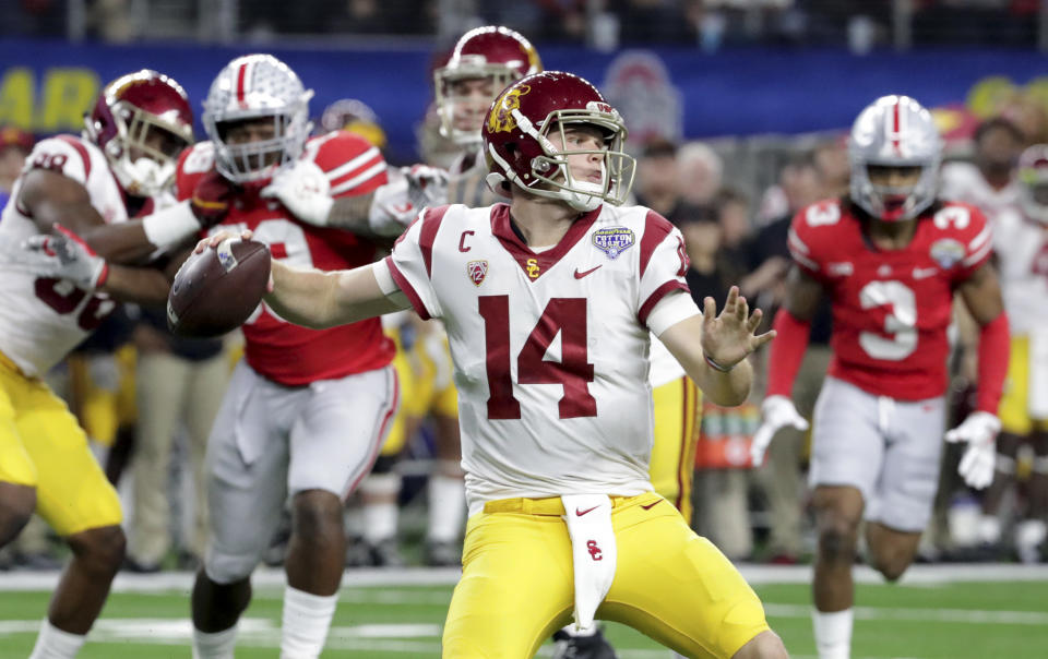 Southern California quarterback Sam Darnold (14) throws a pass with teammates providing blocking against Ohio State during the first half of the Cotton Bowl NCAA college football game in Arlington, Texas, Friday, Dec. 29, 2017. (AP Photo/LM Otero)