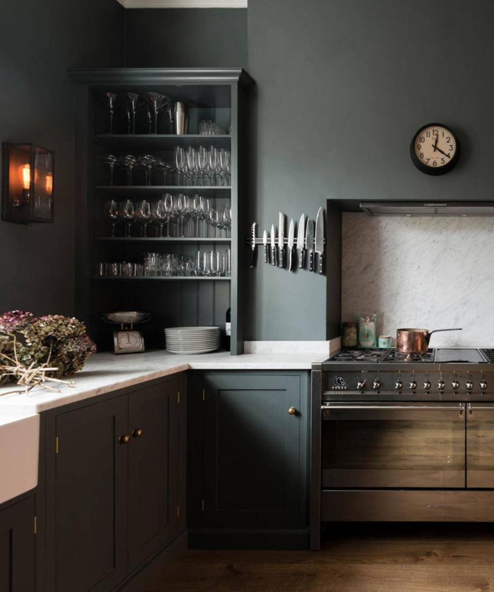 Dark grey kitchen with matching walls by deVOL