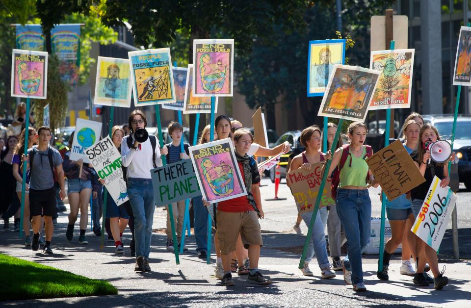 High school and college students from across Eugene march to the Wayne Morse Free Speech Plaza as part of a protest to end the era of fossil fuels.