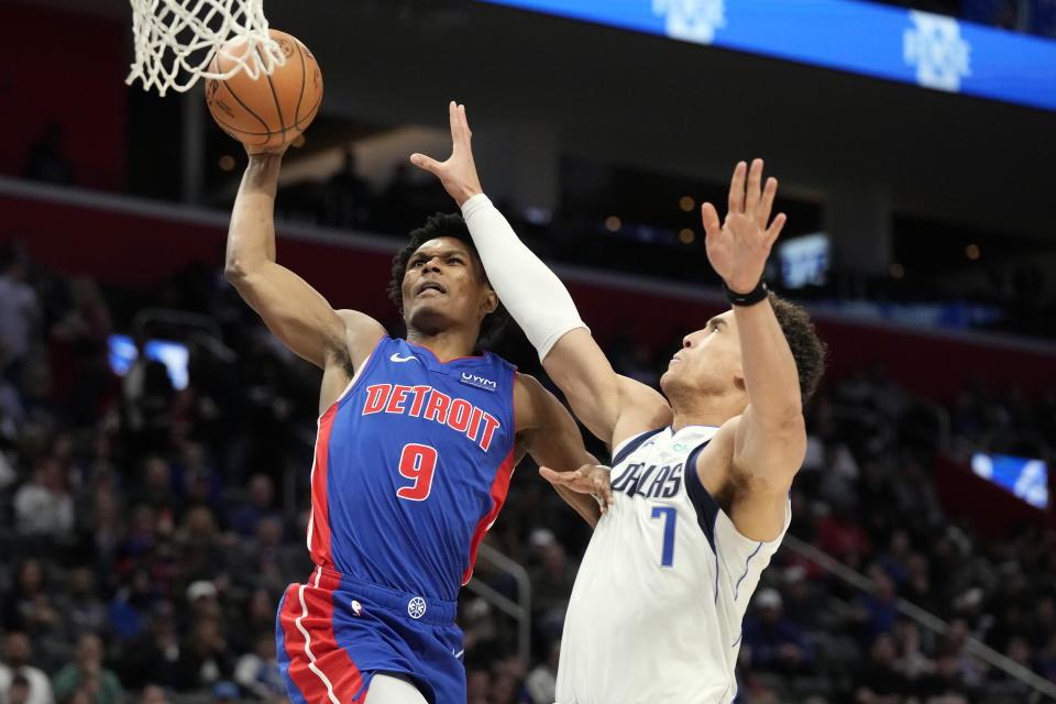 Detroit Pistons forward Ausar Thompson (9) attempts a basket as Dallas Mavericks center Dwight Powell (7) defends during the first half of an NBA basketball game, Saturday, March 9, 2024, in Detroit. (AP Photo/Carlos Osorio)