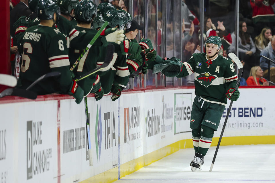 Minnesota Wild left wing Kirill Kaprizov, right, is congratulated after his powerplay goal against the New Jersey Devils during the second period of an NHL hockey game, Thursday, Nov. 2, 2023, in St. Paul, Minn. (AP Photo/Matt Krohn)