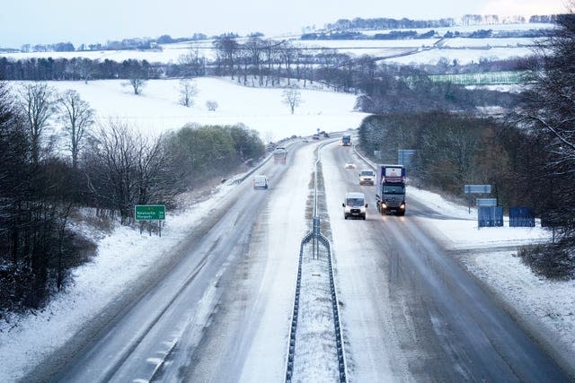 Cars travel along a snow covered A1 motorway at Alnwick in Northumberland as weather warnings for snow and ice are in place across the UK with more are expected