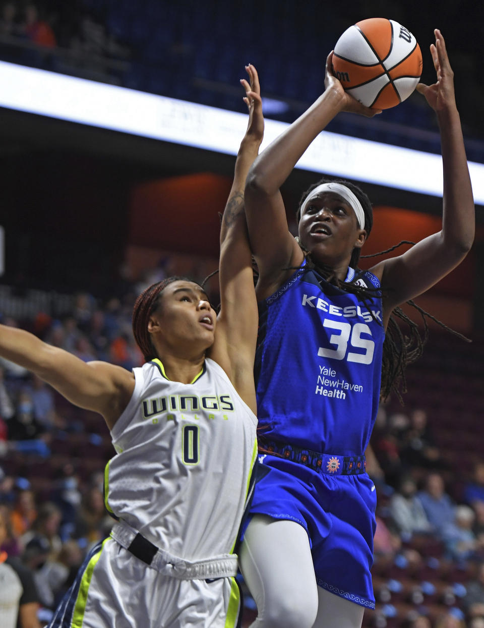 Dallas Wings forward Satou Sabally (0) fouls Connecticut Sun forward Jonquel Jones (35) during a WNBA basketball game Tuesday, May 24, 2022, in Uncasville, Conn. (Sean D. Elliot/The Day via AP)