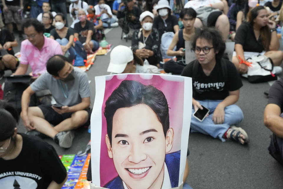 Supporters of the Move Forward Party hold a portrait of Pita Limjaroenrat, the leader of Move Forward Party on his head during protest in Bangkok, Thailand, Thursday, July 27, 2023. The Thai parliament on Thursday set the date of the vote for prime minister next week, for the third time, as political uncertainty continues to grow more than two months after the general election. (AP Photo/Sakchai Lalit)