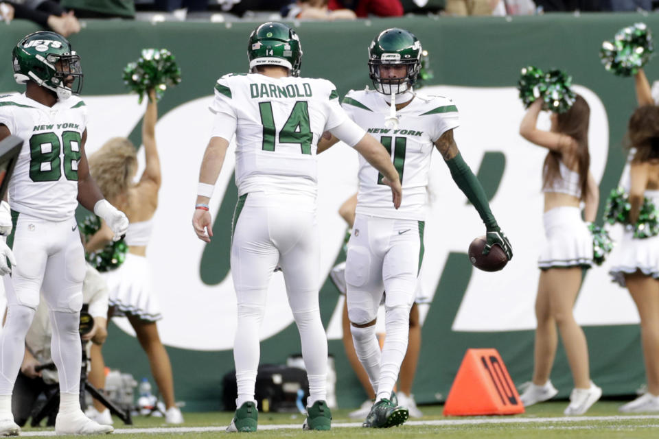New York Jets quarterback Sam Darnold (14) celebrates a touchdown with Robby Anderson (11) during the first half of an NFL football game against the Dallas Cowboys, Sunday, Oct. 13, 2019, in East Rutherford, N.J. (AP Photo/Adam Hunger)