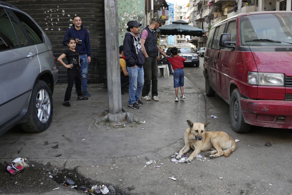 Residents hang out at Bab al-Tebanneh, one of Tripoli's poorest slums in the northern city of Tripoli, Lebanon, Wednesday, April 27, 2022. A week ago, a boat carrying around 60 Lebanese trying to escape their country and reach Europe sank in the Mediterranean after colliding with a Navy ship. At least seven people are known dead and at least six are missing. The tragedy underscored the desperation among many Lebanese after the collapse of their country's economy. (AP Photo/Hassan Ammar)