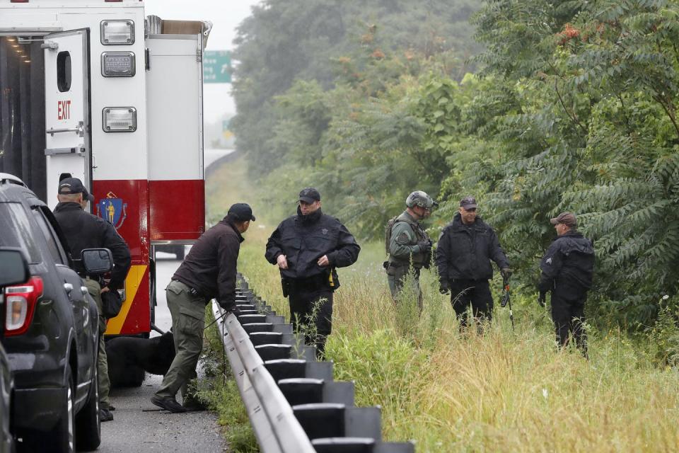 <span class="caption">Police work in the area of an hours-long standoff with a group of armed men that partially shut down a major highway in in Wakefield, Mass., in July 2021.</span> <span class="attribution"><span class="source">(AP Photo/Michael Dwyer)</span></span>