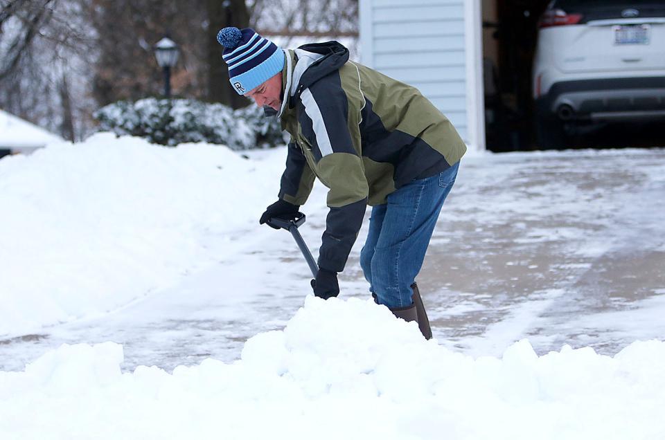 Lee Conwell shovels the driveway of his home at the corner of Southwood Drive and Greenbriar Drive in Ashland on Monday, Jan. 17, 2022.