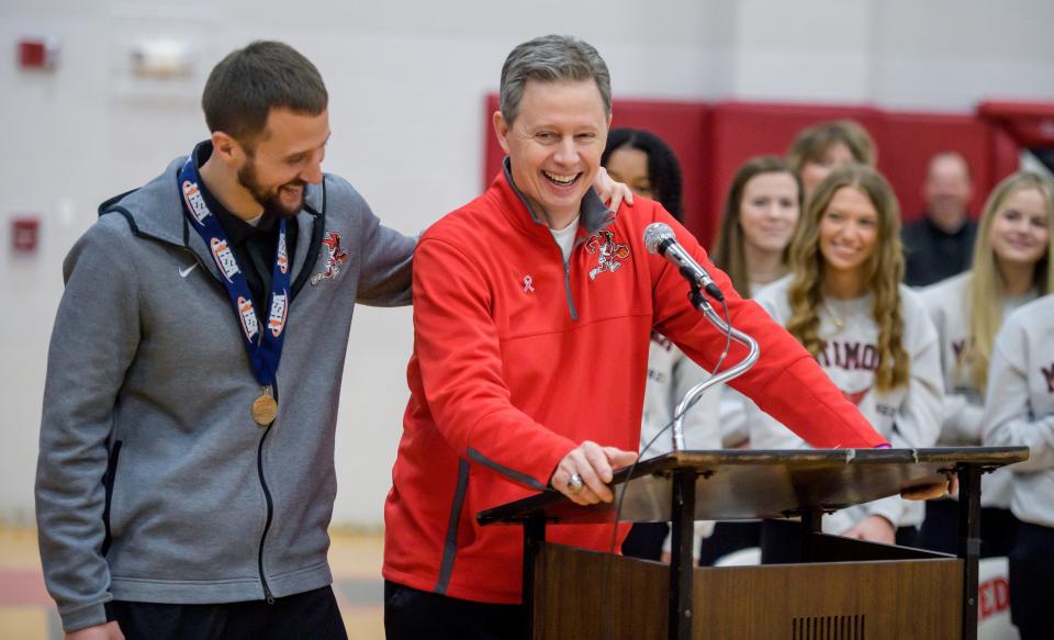 Metamora head basketball coach Danny Grieves shares a laugh with assistant coach Justin Dehm after singing Dehm's praises during a celebration of the Redbirds' Class 3A state championship Sunday, March 12, 2023 at Metamora Township High School.