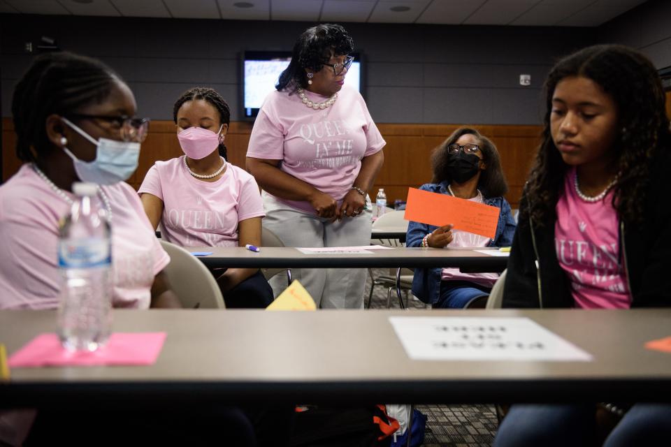 Mentor Annette Owens, center, talks with some of the young women attending the Queen in Me mentoring program at Fayetteville Technical Community College on Monday, June 13, 2022. The week-long program will mentor them on topics including life skills, etiquette and leadership development. 