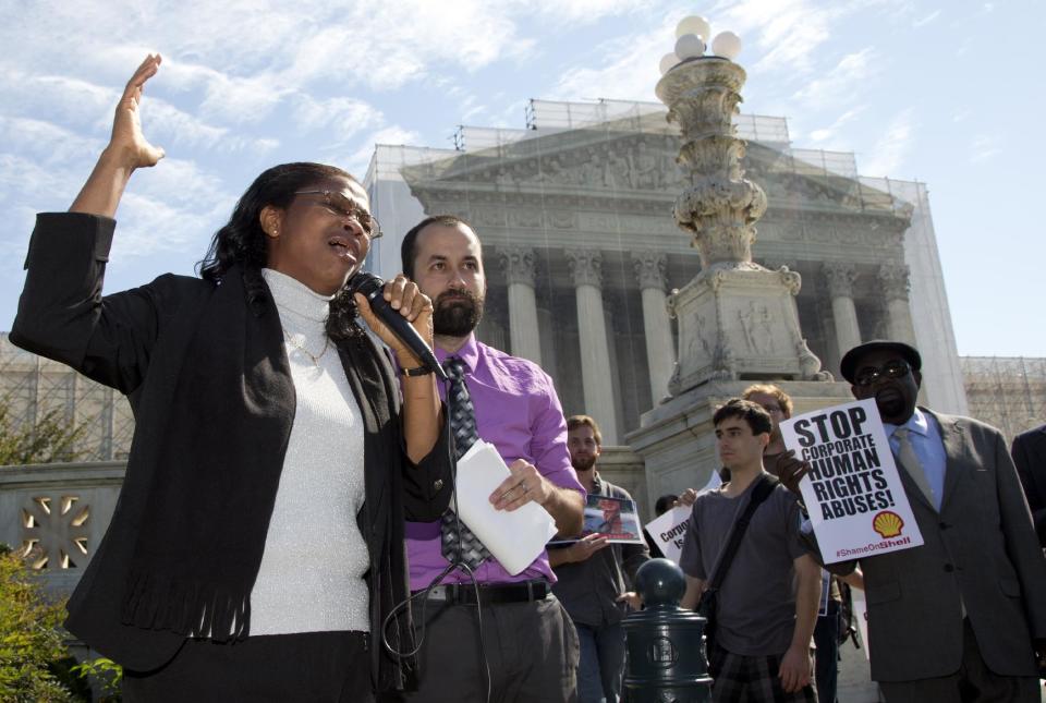 Nigerian widow Esther Kiobel, a plaintiff in Kiobel v. Royal Dutch Petroleum, cries as she speaks outside the Supreme Court in Washington, Monday, Oct. 1, 2012. Standing with her second from left is Brad Weikel with EarthRights International. (AP Photo/Carolyn Kaster)