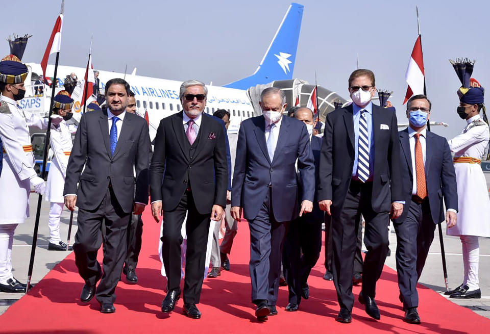 In this picture provided by Pakistan's Ministry of Foreign Affairs, Abdullah Abdullah, chairman of Afghanistan's High Council for National Reconciliation, second left, is accompanied by Pakistani officials upon his arrival at Nur Khan airbase in Rawalpindi, Pakistan, Monday, Sept. 28, 2020. Afghanistan's top official in negotiations with the Taliban arrived in Pakistan's capital Monday on a three-day trip during which he will meet with the country's prime minister and other government officials. (Ministry of Foreign Affairs via AP)