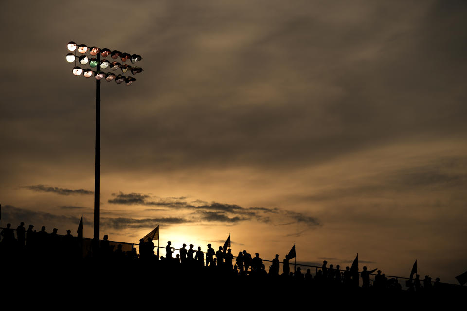 Fans watch as the sun starts to set behind them during a NASCAR Cup Series auto race at World Wide Technology Raceway, Sunday, June 4, 2023, in Madison, Ill. (AP Photo/Jeff Roberson)