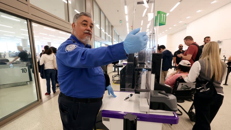 Julian Martinez, a transportation security officer with the Transportation Security Administration, motions for a traveler to approach a TSA security checkpoint at Salt Lake City International Airport in Salt Lake City on Tuesday, Sept. 19, 2023.