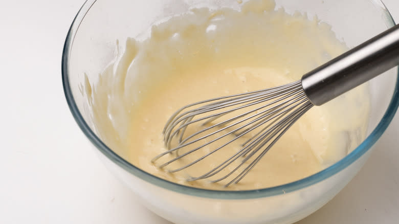 mixing fritter batter in bowl