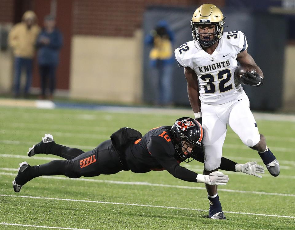 Massillon defender Zachary Liebler tackles Hoban running back Lamar Sperling in the first half during this OHSAA Division II state semifinal game Friday, Nov. 25, 2022 at the University of Akron.