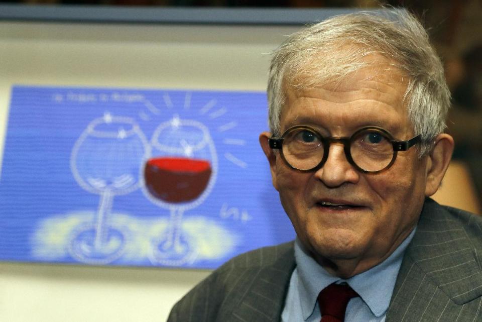 FILE - In this Friday, Feb. 3, 2017 file photo, artist David Hockney unveils the bottle design for the 2014 vintage wine of Château Mouton Rothschild in London. It's not often an artist finds himself occupying 12 rooms of London's leading museum of British art and the front page of populist tabloid The Sun. But David Hockney is unique. (AP Photo/Frank Augstein, file)