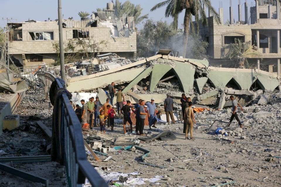 DEIR AL-BALAH, GAZA - JULY 27: Palestinians seek for their belongings among wreckage as they flee to other areas after Israeli attack struck Khadija School, which also served as a field hospital in Deir al-Balah, Gaza on July 27, 2024. As a result of the attack, the school building was completely destroyed. (Photo by Ashraf Amra/Anadolu via Getty Images)