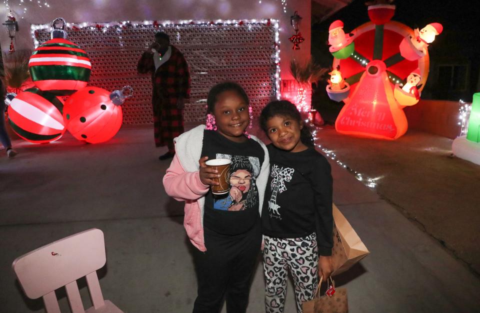 Neighbors enjoy a Christmas celebration at a home in Desert Hot Springs on Friday.