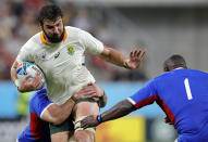 South Africa's Lood de Jager runs at Namibia's Desiderius Sethie, right, during the Rugby World Cup Pool B game at the City of Toyota Stadium between South Africa and Namibia in Toyota City, Japan, Saturday, Sept. 28, 2019. (AP Photo/Christophe Ena)