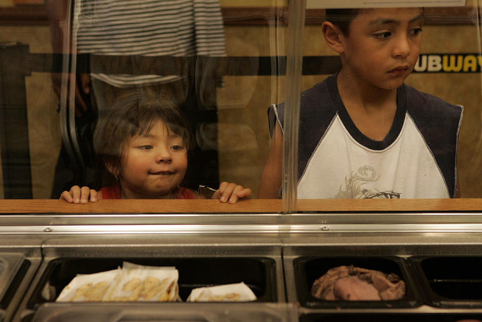 A kid looking at a food display