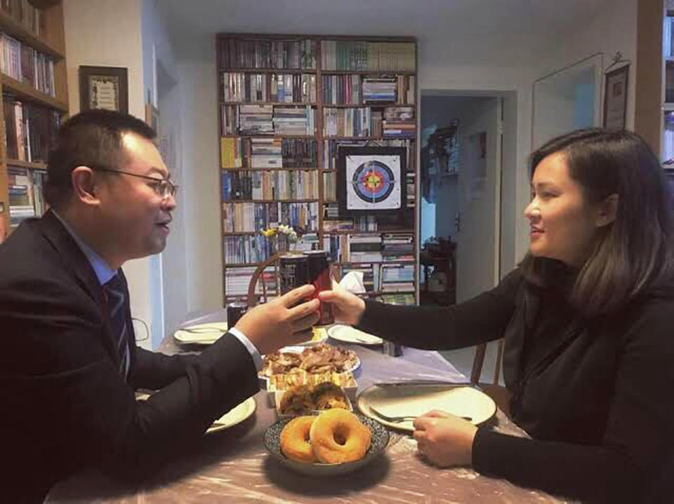 In this 2016 photo provided by ChinaAid, pastor Wang Yi, left, toasts with his wife at their home. China on Monday, Dec. 30, 2019, sentenced the prominent pastor who operated outside the Communist Party-recognized Protestant organization to nine years in prison. The People's Intermediate Court in the southwestern city of Chengdu said Wang Yi was also convicted of illegal business operations, fined and had his personal assets seized. (ChinaAid via AP)
