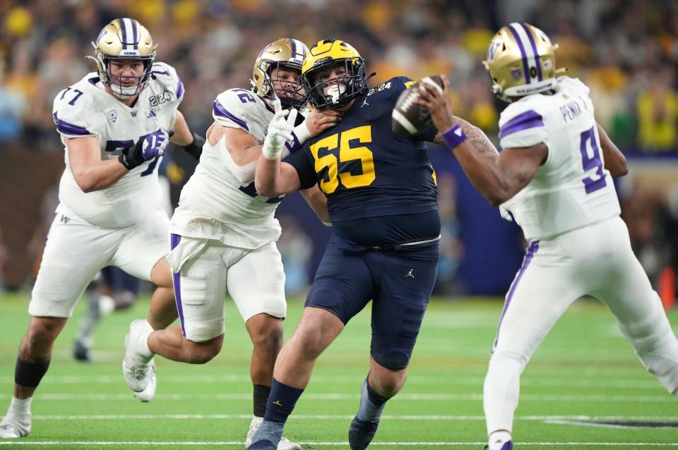 Michigan defensive lineman Mason Graham looks to tackle Washington quarterback Michael Penix Jr. during the second half of U-M's 34-13 win in the College Football Playoff national championship game in Houston on Monday, Jan. 8, 2024.