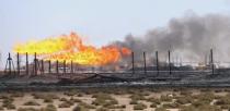 FILE PHOTO: Flames emerge from the flare stacks at the West Qurna-1 oilfield, which is operated by ExxonMobil, near Basra