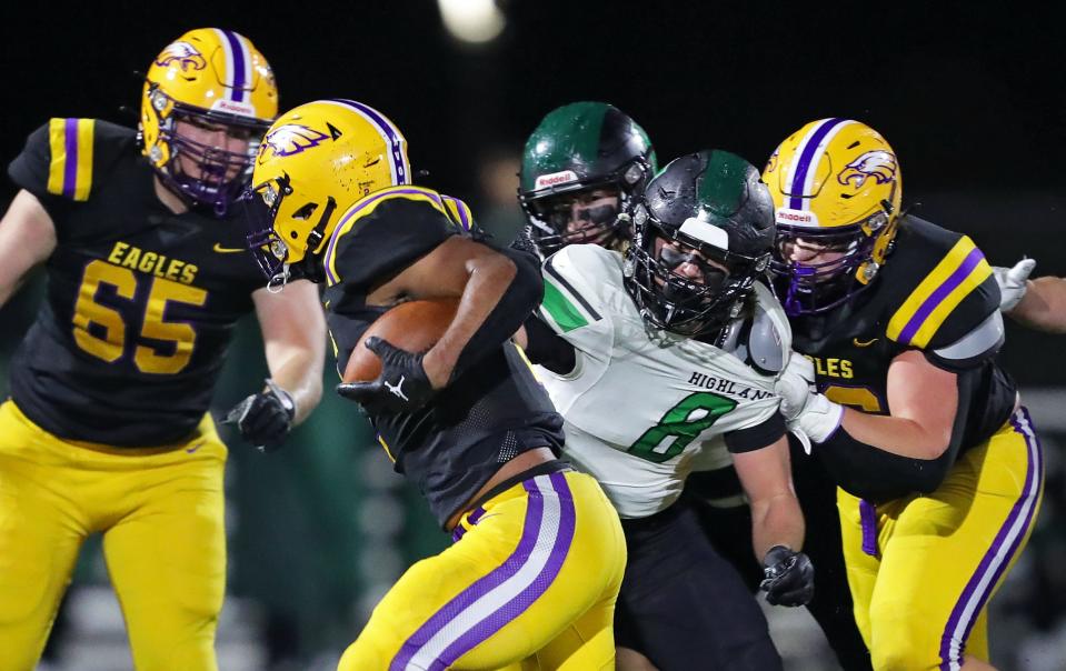 Highland linebacker Tommy Shondel, facing, attempts to bring down Avon running back Jakorion Caffey during the first half of a Division II regional championship football game at Pat Catan Stadium, Friday, Nov. 17, 2023, in Strongsville, Ohio.