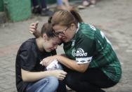 <p>Fans of Brazil’s soccer team Chapecoense mourn outside the Arena Conda stadium in Chapeco, Brazil, Tuesday, Nov. 29, 2016. A chartered plane that was carrying the Brazilian soccer team to the biggest match of its history crashed into a Colombian hillside and broke into pieces, Colombian officials said Tuesday. (AP Photo/Andre Penner) </p>