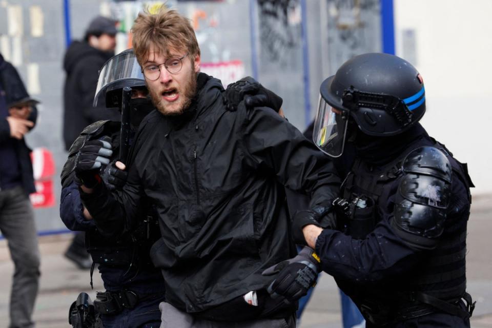 Police officers detain a protester during clashes as part of a demonstration (AFP via Getty Images)