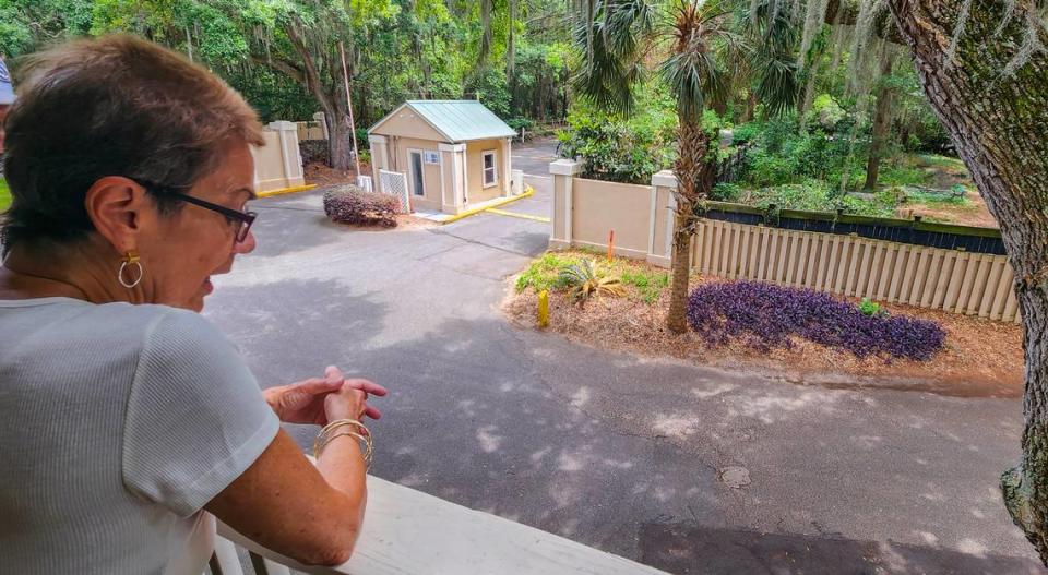 Terri Coco, looks from the balcony of her home at The Spa on Port Royal Sound, that shows the fences that separate the community from the ‘cat sanctuary’ on May 9, 2023 on Hilton Head Island. Coco says on numerous occasions she has found cat feces at her door and believes the feral cats are the culprits.