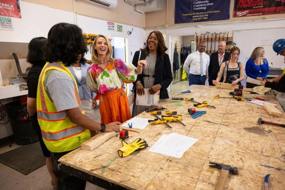 First Partner Jennifer Siebel Newsom, center, joined by Washington Unified School District Superintendent Cheryl Hildreth, laughs with students in the Career Technical Education Pathways program at River City High School in West Sacramento on Thursday. Paul Kitagaki Jr./pkitagaki@sacbee.com