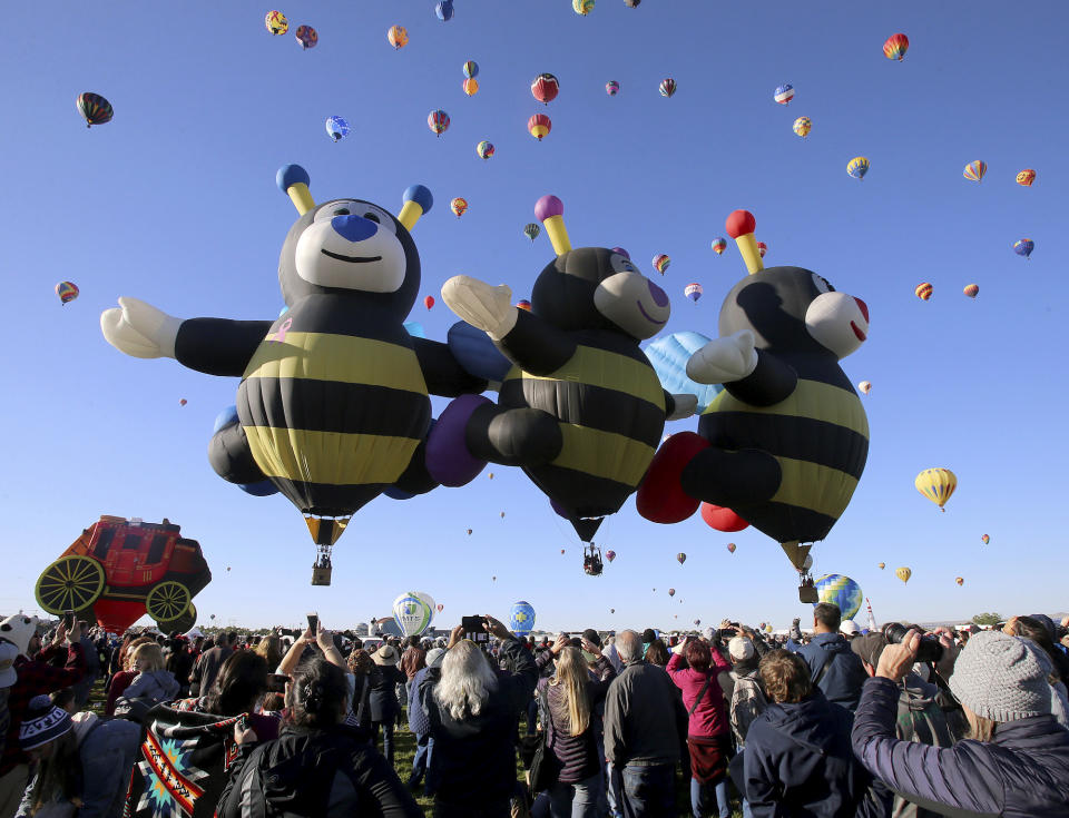 Spectators watch as hot air balloons liftoff at the Albuquerque International Balloon Fiesta in Albuquerque, N.M., Sunday, Oct. 6, 2019. (Jerry Larson/Waco Tribune-Herald via AP)