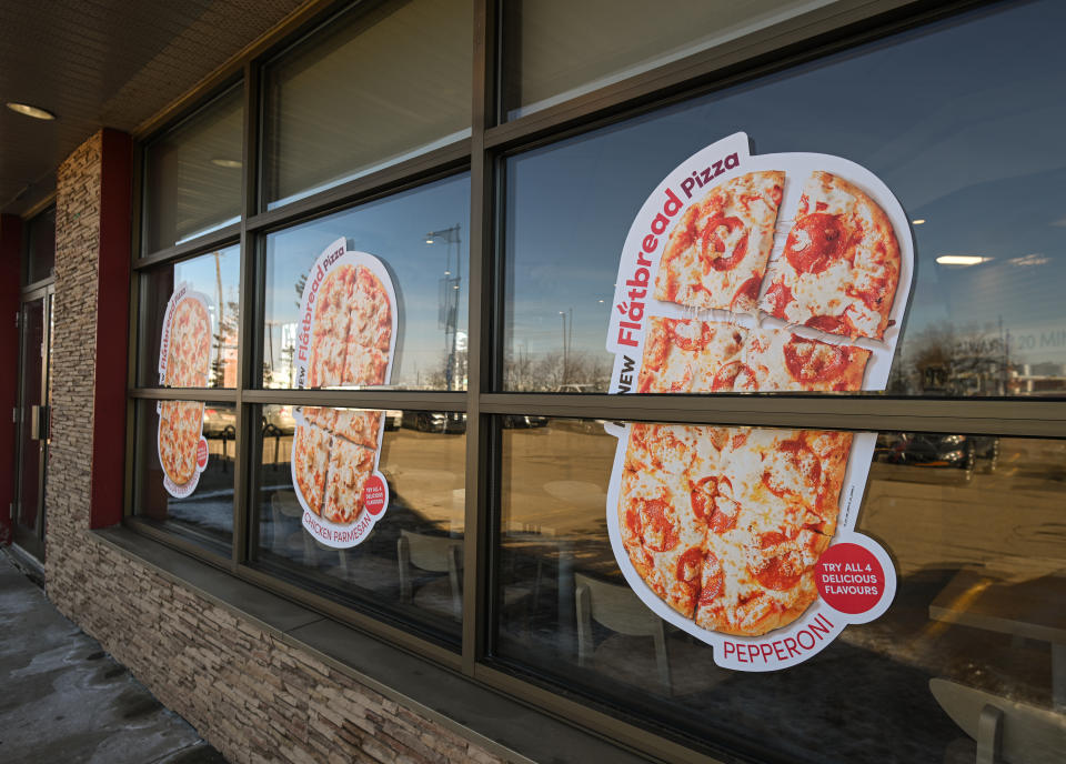 EDMONTON, CANADA - APRIL 17:
Stickers with images of pizza seen on the Tim Hortons' facade as the company launches pizza nationwide, aiming to expand its brand into the afternoon and evening markets, on April 17, 2024, in Edmonton, Alberta, Canada. (Photo by Artur Widak/NurPhoto via Getty Images)